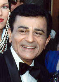 Casey Kasem, the voice of American Top 40 and the defining host of 80s radio countdown shows, smiling in a tuxedo