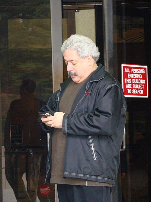 Radio consultant Lee Abrams, who built the structured AOR format, checking his phone outside a building