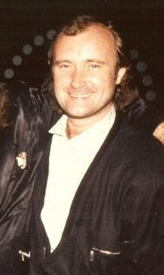 Phil Collins smiling at an event in the 1980s