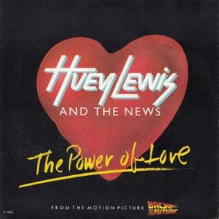 The single cover art for The Power of Love by Huey Lewis and the News, a red heart with the band name and title in bold lettering, referencing Back to the Future
