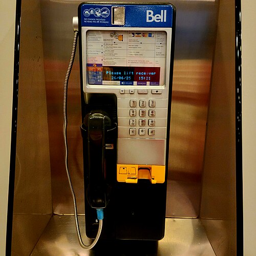 A Bell payphone in a public booth, the kind of phone strangers used to dial 867-5309 in their own area code and ask for Jenny