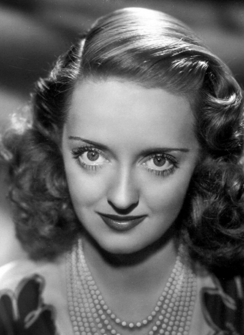 A 1939 black and white publicity portrait of actress Bette Davis