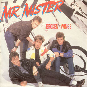 The Mr. Mister Broken Wings single cover, the band posed against a graffiti backdrop