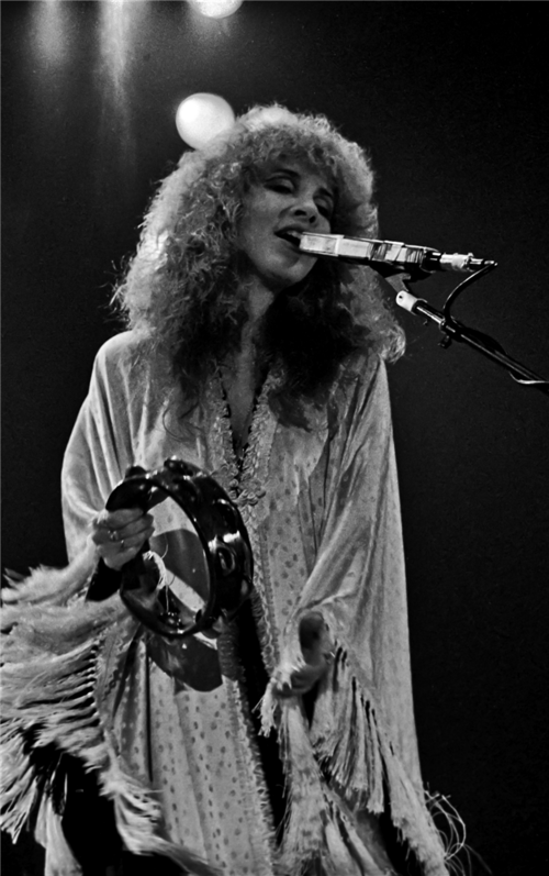 Stevie Nicks singing into a microphone in 1980
