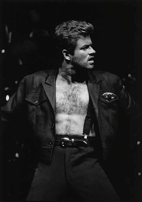 George Michael performing on stage during the Faith era