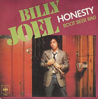 The Billy Joel Honesty single sleeve, with the artist standing in a doorway holding a trumpet