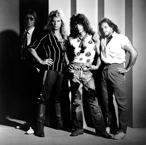A black and white group portrait of the four members of Van Halen standing together, 1984