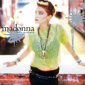The Madonna Like a Virgin single cover, a portrait in a lace top and layered necklaces against a brick wall