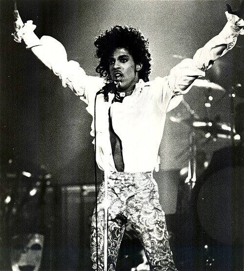 Prince performing on stage in a 1984 publicity photo