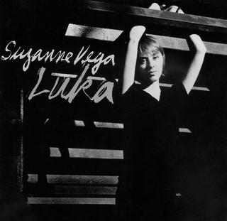 The single cover art for Luka by Suzanne Vega, a black and white photo of Vega beneath a fire escape ladder