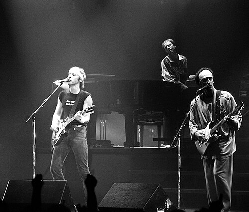 Dire Straits performing on stage in 1985, with Mark Knopfler on guitar