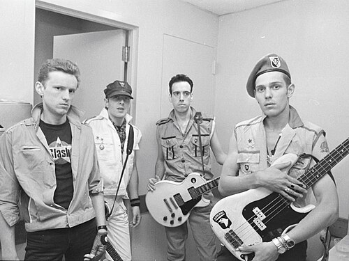 The four members of The Clash backstage in San Diego, 1982, holding guitars