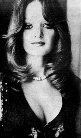 A publicity portrait of Bonnie Tyler with long wavy hair and a pearl necklace