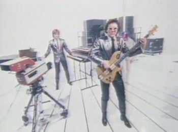 A frame from the Video Killed the Radio Star music video showing the band performing on set