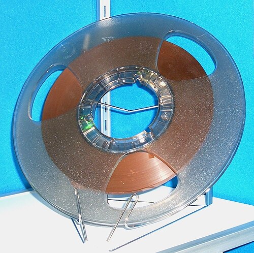 A large reel of magnetic recording tape, the kind used to capture full radio broadcasts